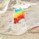 A bird's eye view of a mining site with a GroundProbe BlastVision software heatmap layer on top of the photo to highlight slope instability